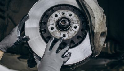 Mechanic changing brake discs in car service